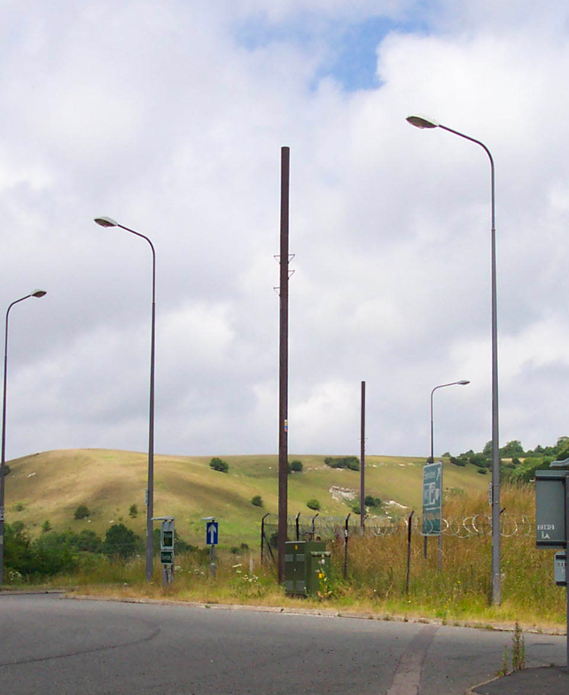 A timber clad pole erected in a field.