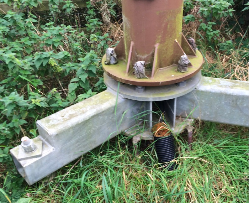 A screw pile foundation at the base of a telegraph pole.