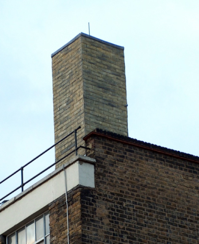 A GRP brick chimney on top of a roof.