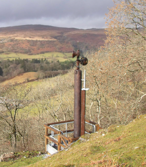Large steel telecommunication mast in a greenfield site.